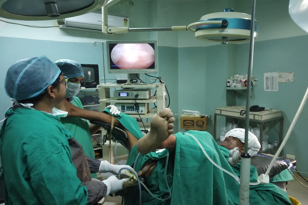 Medical team performing an endoscopic urological procedure in an operating room